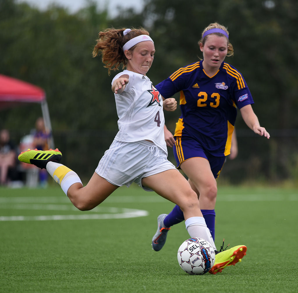 Savana Johnson kicks kicks the ball away from Blake Allison
